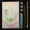 A light-up greeting card featuring two aliens celebrating Christmas. An LED shines atop the tree. 